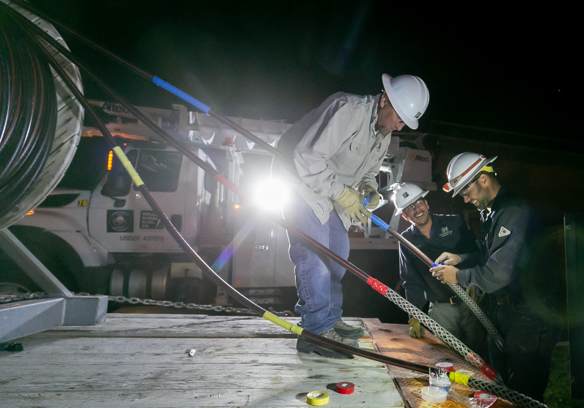 Linemen; left to right; Jacob Manning, Ismael Ramirez, and Kyle Murphy for Wells REC fix a bad underground cable at the Motel 6 in Wells, Nevada on June 12th, 2019